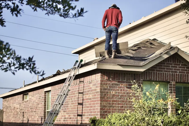 Professional roofer working on a residential roof in Copperfield
